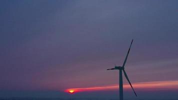 Silhouette of energy producing wind turbines at sunset, Poland video