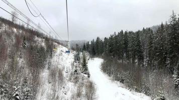 View from the chair to the chair lift at a ski resort in winter video