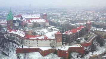 Aerial view of Wawel royal Castle and Cathedral, Vistula River, park, promenade and walking people in winter. Poland video