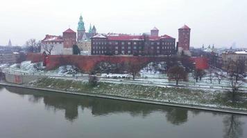 Aerial view of Wawel royal Castle and Cathedral, Vistula River, park, promenade and walking people in winter. Poland video