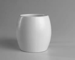 White cup on a gray background. Side view. photo