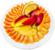 Peeled tangerines sliced and red and yellow apples cut into slices on a white plate. Healthy food concept. photo