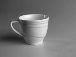White mug on a gray background. side view. photo
