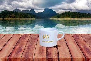 White coffee cup  on wood table with nature background. photo