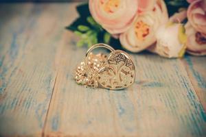 gold bracelet with heart on color wood photo