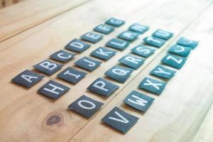 English alphabet letters on wood table. photo