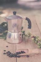 Fresh coffee beans on wood with a  moga pot photo