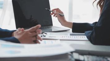 Financial analysts analyze business financial reports on a digital tablet planning investment project during a discussion at a meeting of corporate showing the results of their successful teamwork. video