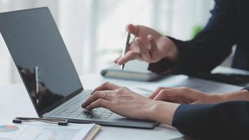 Financial analysts analyze business financial reports on a digital tablet planning investment project during a discussion at a meeting of corporate showing the results of their successful teamwork. video