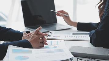 Financial analysts analyze business financial reports on a digital tablet planning investment project during a discussion at a meeting of corporate showing the results of their successful teamwork. video