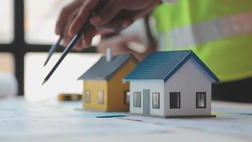Construction and structure concept of Engineer or architect meeting for project working with partner and engineering tools on model building and blueprint in working site, contract for both companies. video