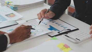 Financial analysts analyze business financial reports on a digital tablet planning investment project during a discussion at a meeting of corporate showing the results of their successful teamwork. video