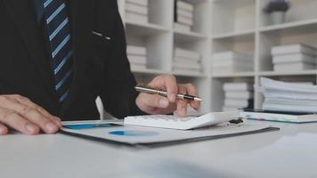 Financial analysts analyze business financial reports on a digital tablet planning investment project during a discussion at a meeting of corporate showing the results of their successful teamwork. video