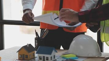 Construction and structure concept of Engineer or architect meeting for project working with partner and engineering tools on model building and blueprint in working site, contract for both companies. video