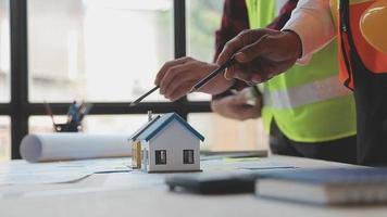 Construction and structure concept of Engineer or architect meeting for project working with partner and engineering tools on model building and blueprint in working site, contract for both companies. video