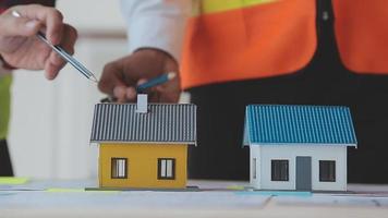 Construction and structure concept of Engineer or architect meeting for project working with partner and engineering tools on model building and blueprint in working site, contract for both companies. video