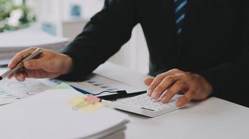 Financial analysts analyze business financial reports on a digital tablet planning investment project during a discussion at a meeting of corporate showing the results of their successful teamwork. video