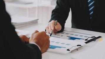 Financial analysts analyze business financial reports on a digital tablet planning investment project during a discussion at a meeting of corporate showing the results of their successful teamwork. video