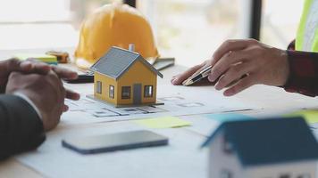 Construction and structure concept of Engineer or architect meeting for project working with partner and engineering tools on model building and blueprint in working site, contract for both companies. video