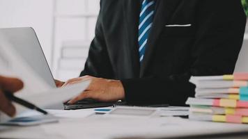 Financial analysts analyze business financial reports on a digital tablet planning investment project during a discussion at a meeting of corporate showing the results of their successful teamwork. video