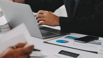 Financial analysts analyze business financial reports on a digital tablet planning investment project during a discussion at a meeting of corporate showing the results of their successful teamwork. video