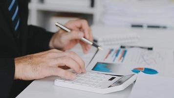 Financial analysts analyze business financial reports on a digital tablet planning investment project during a discussion at a meeting of corporate showing the results of their successful teamwork. video