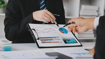 Financial analysts analyze business financial reports on a digital tablet planning investment project during a discussion at a meeting of corporate showing the results of their successful teamwork. video