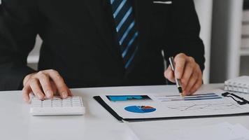 Financial analysts analyze business financial reports on a digital tablet planning investment project during a discussion at a meeting of corporate showing the results of their successful teamwork. video