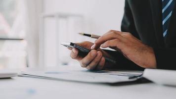 Financial analysts analyze business financial reports on a digital tablet planning investment project during a discussion at a meeting of corporate showing the results of their successful teamwork. video
