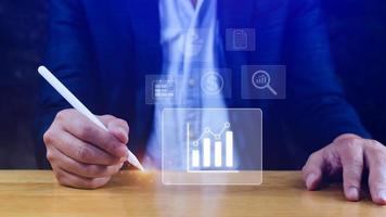 Big data analytics and business intelligence BI concept with chart and graph icons on digital screen interface and business people in the background. photo