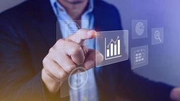 Big data analytics and business intelligence BI concept with chart and graph icons on digital screen interface and business people in the background. photo
