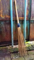 old broom leaning against the gate photo