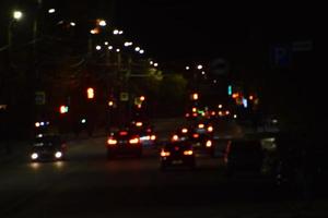 Multicolored lights of the night city. Glowing city road at night. photo