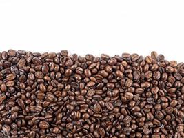 Arabica coffee beans roasted fragrant ready to make coffee that people like to drink placed on the white background looks beautiful photo