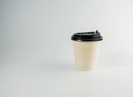 Front top view, white coffee paper cup black lid, filled with hot black coffee americano, no sugar milk, ready to drink, refreshing. aroma awake fresh to work placed on a white isolated background photo
