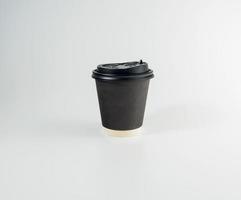 Front top view, black coffee paper cup black lid, filled with hot black coffee americano, no sugar milk, ready to drink, refreshing. aroma awake fresh to work placed on a white isolated background photo