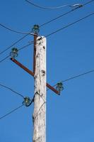 Old wooden high voltage post or high voltage tower photo