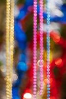 Colorful Christmas ornament decorations. Defocused abstract blurry bokeh background of balls, beads and tinsel photo