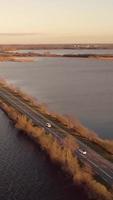 Road extends straight ahead surrounded by water video