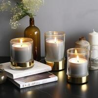 beautiful cylindrical candle glowing on glass photo
