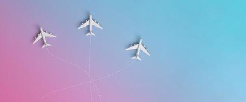 three airplanes travelling to different destinations in gradient background. holiday or business trip concept. photo