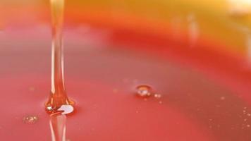 Close up of fresh honey pouring into a bowl video