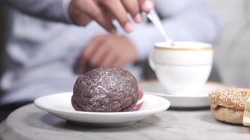 Young man hand pick cookies and drinking tea video