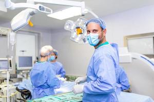 Portrait of surgeon standing in operating room, ready to work on a patient. Medical worker surgical uniform in operation theater. photo