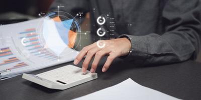 Businessman reading graph report and business statistics charts ,Analysis and improvement of corporate strategy ,Statistics and Data Concepts ,update annual budget accounts ,business growth graph photo