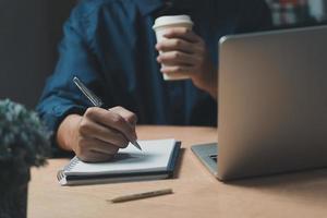 Businessperson reading and writing on book.education studying knowledge development and cognition learning concept. photo