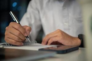 Businessperson reading and writing on book.education studying knowledge development and cognition learning concept. photo