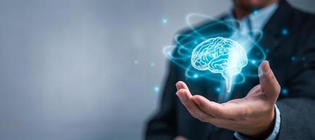 Hand touching brain of AI, Artificial Intelligence and machine learning of futuristic technology. AI network of brain on business analysis, innovative and business growth development. photo
