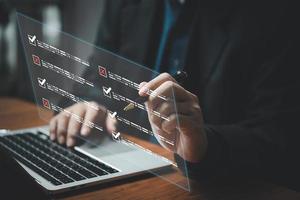 businessman checklist and document on virtual screens concept, business people check electronic digital questionnaire, evaluation, online survey, communication technology. photo