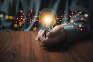 hand hold light bulb.Inspiration and Creativity Concepts.Innovation technology in science and communication network connection. photo